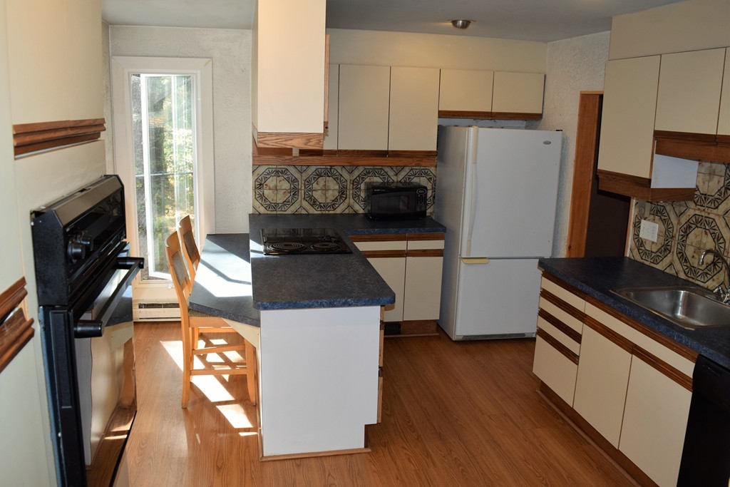 641 Wheelwright Road Barre, MA 01005 - Photo 10 of 26 a kitchen with a refrigerator stove and wooden floor