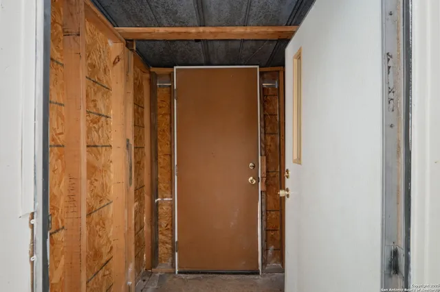 a view of a room that has a bed and a mirror
