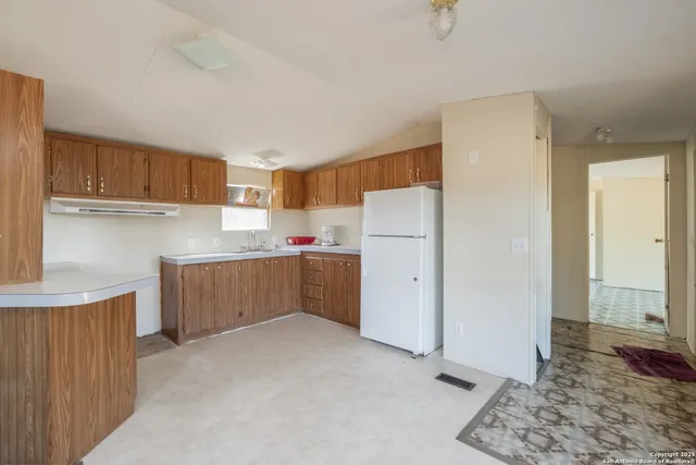 a kitchen with a refrigerator and a sink