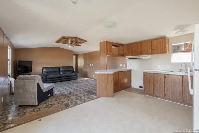 a kitchen with stainless steel appliances granite countertop a sink a stove and a refrigerator