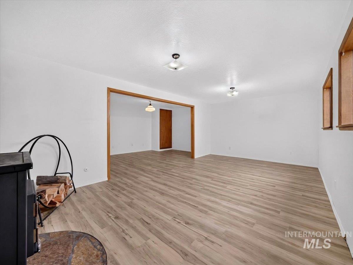 8989 Hillview Road Emmett, ID 83617 - Photo 31 of 50 Spacious living area featuring wood-finish flooring, light-toned walls, and recessed lighting