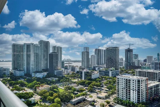 a view of a city with plants and a yard
