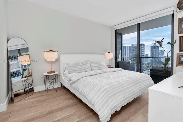 a bedroom with a bed and a large window