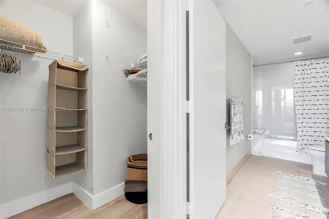 a bathroom with a double vanity sink toilet and shower