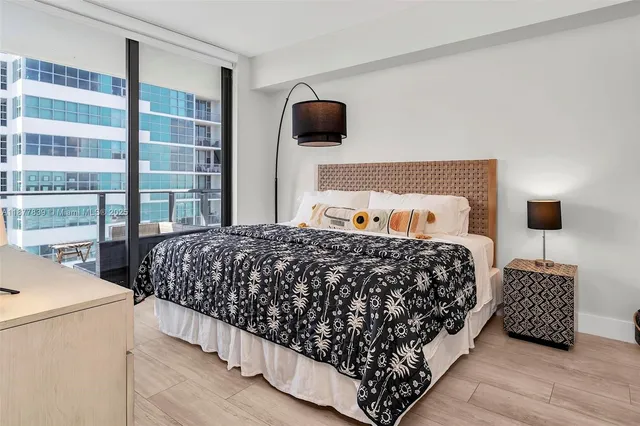 a bedroom with a bed and flat screen tv