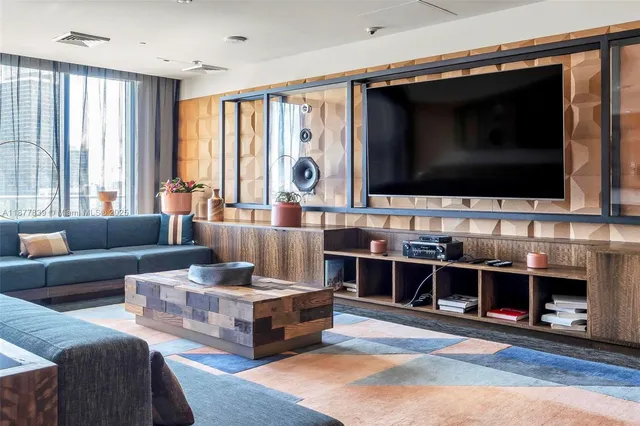 a dining room with furniture and a floor to ceiling window