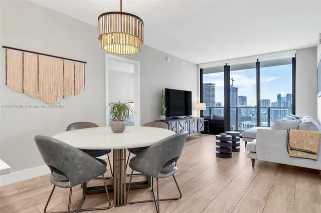 a living room with furniture and a floor to ceiling window