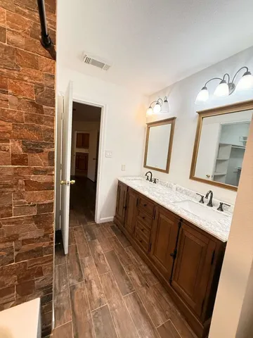 a spacious bathroom with a double vanity sink and a mirror