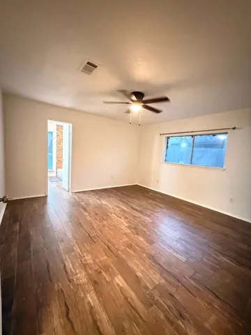 a view of a room with wooden floor