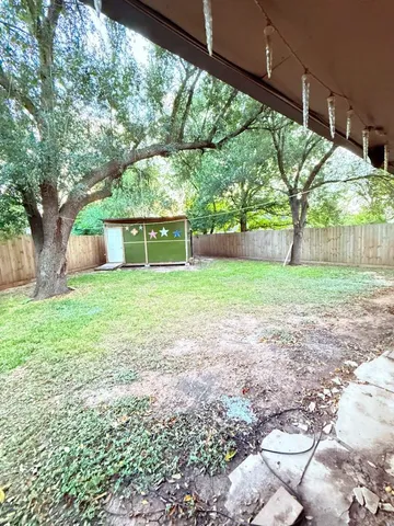 a view of a house with backyard and a sitting area