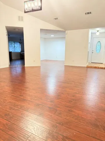 a view of a room with wooden floor