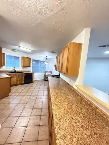 a large white kitchen with a stove a sink and a refrigerator