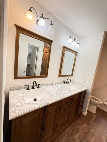 a bathroom with a double vanity sink and a mirror