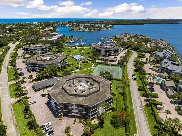 an aerial view of a house with a garden and lake view