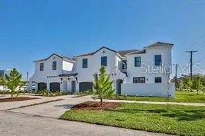 a front view of a house with a garden and yard