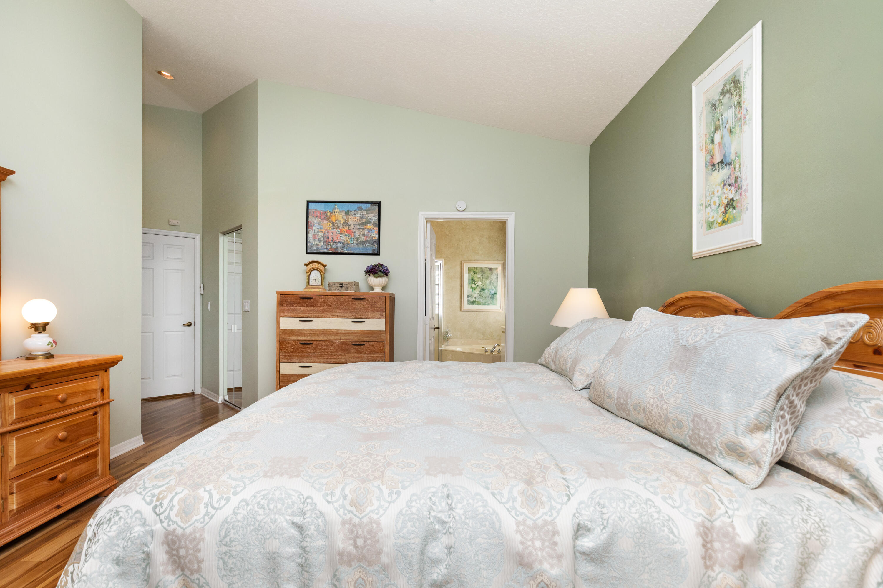 6698 Vía Roma Delray Beach, FL 33446 - Photo 13 of 50 a bedroom with a bed and a chandelier