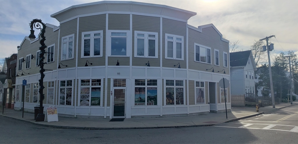 a front view of a building with a garden