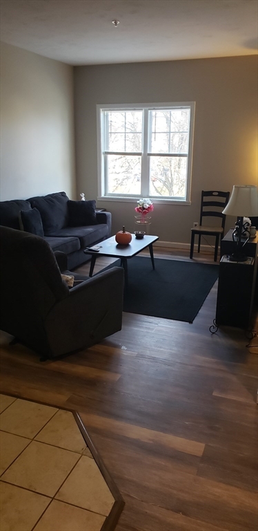 95 Park Street, Unit 1 Attleboro, MA 02703 - Photo 5 of 6 a living room with furniture and a flat screen tv
