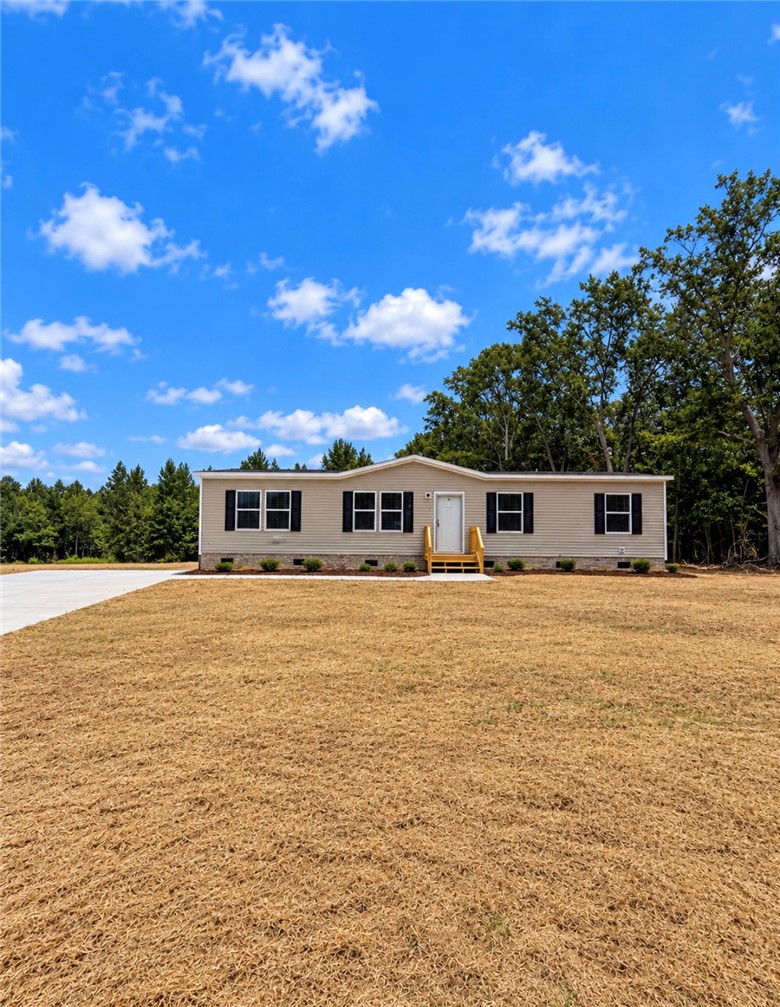 1411 Slaton Road Townville, SC 29689 - Photo 1 of 17 Crisp vinyl siding and classic shutters define this inviting single-level home set against a wooded backdrop.