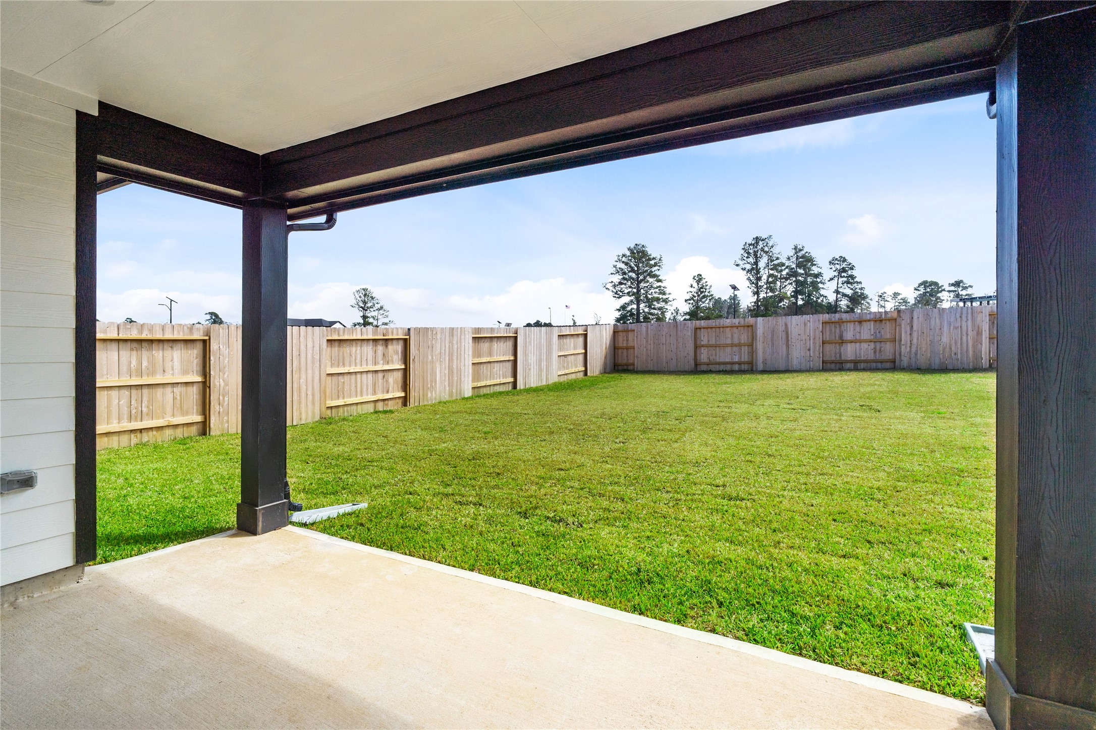 19645 Montgomery Rdg Way Montgomery, TX 77316 - Photo 33 of 41 The spacious covered patio offers a tranquil outdoor retreat, perfectly designed for savoring your quiet morning coffee or unwinding during peaceful evening relaxation.