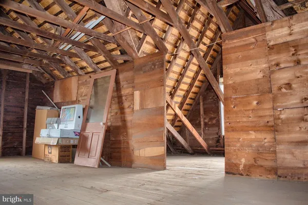 a view of a big room with wooden floors and stairs
