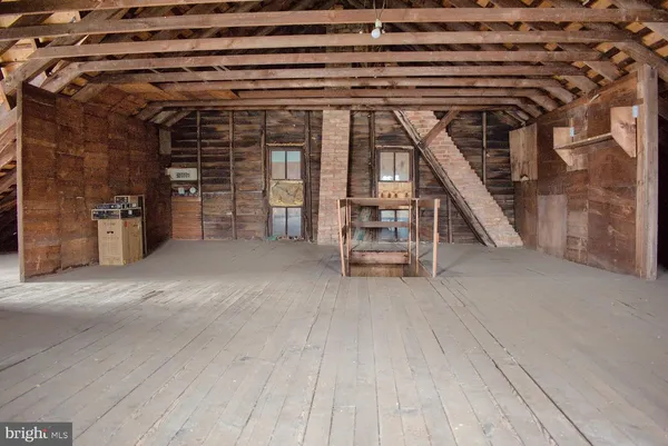 a view of a house with wooden floor and a barbeque