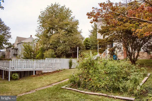 a backyard of a house with a yard and outdoor seating