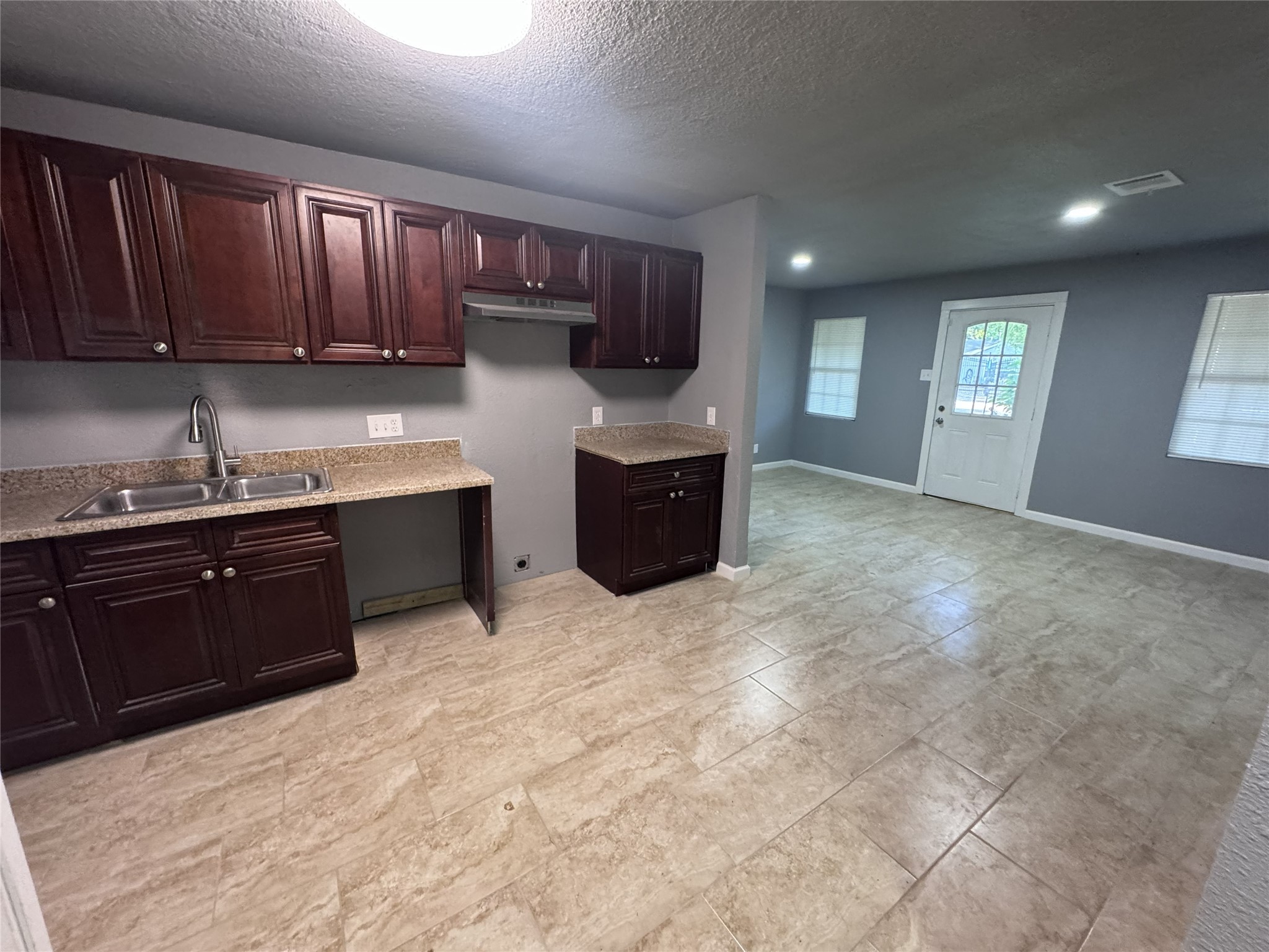 4933 Alvin Street Houston, TX 77033 - Photo 3 of 9 a kitchen with stainless steel appliances granite countertop a stove refrigerator sink and cabinets
