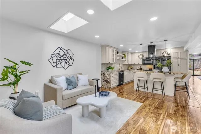 a living room with furniture and kitchen view