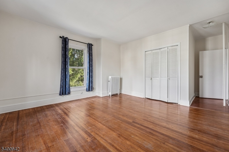24 Franklin Place Summit, NJ 07901 - Photo 15 of 36 a view of an empty room with wooden floor and a window