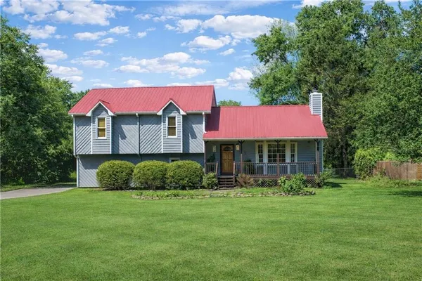 a front view of a house with a garden
