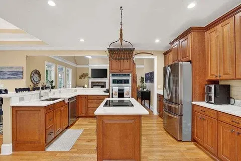 a kitchen with stainless steel appliances a sink stove and refrigerator