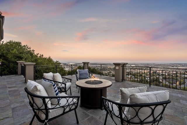 a roof deck with a table and chairs