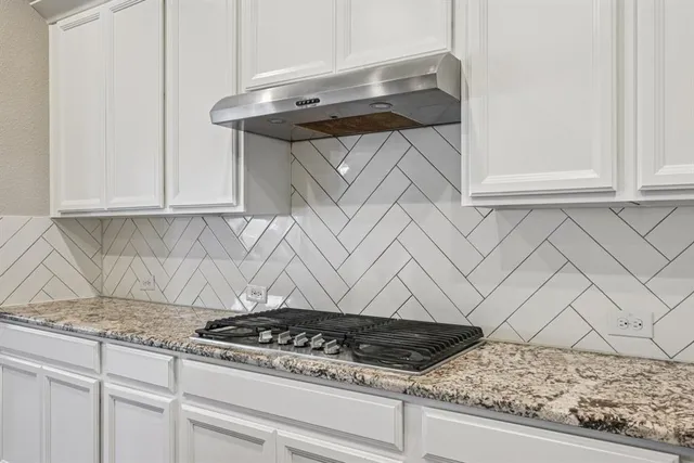 a stove top oven sitting inside of a kitchen
