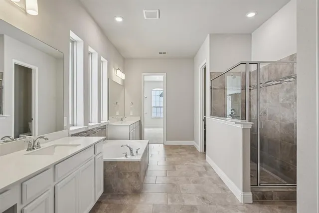 a bathroom with a double vanity sink mirror and shower