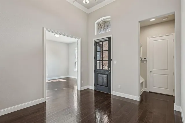 an empty room with wooden floor and closet