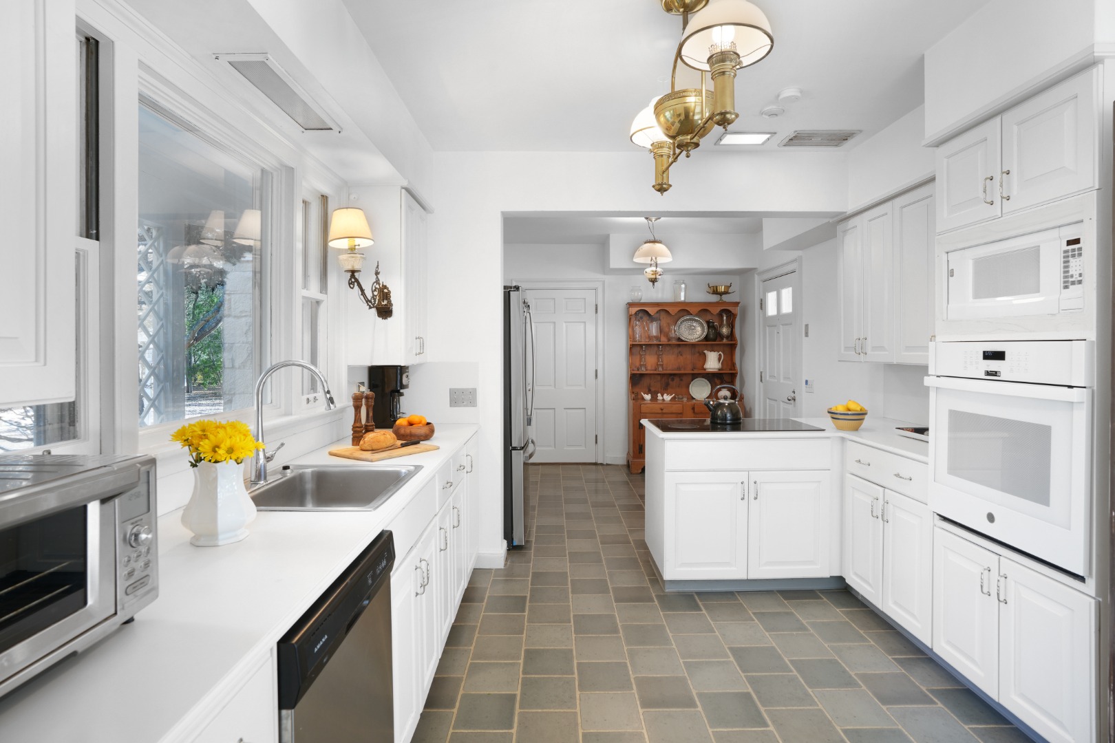 57 Hines Point Road Vineyard Haven, MA 02568 - Photo 15 of 29 a kitchen with a sink dishwasher and white cabinets with wooden floor