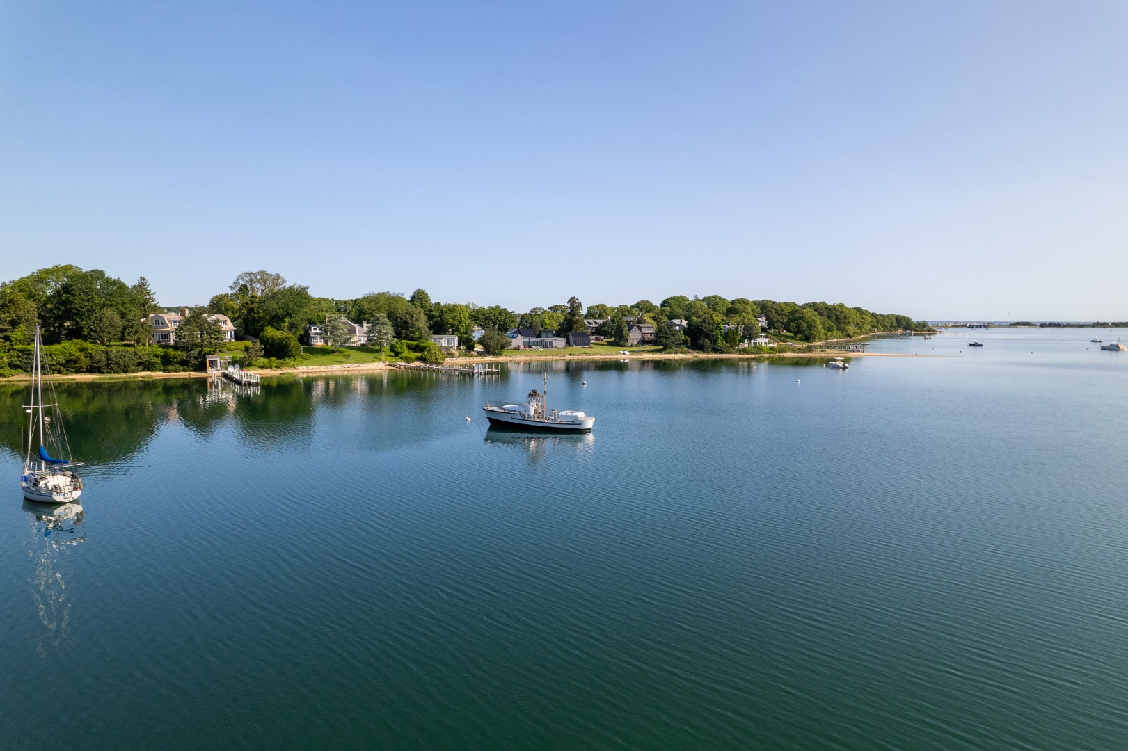 57 Hines Point Road Vineyard Haven, MA 02568 - Photo 7 of 29 a view of a lake with houses in the back