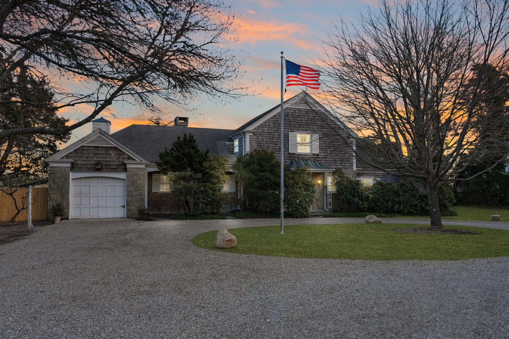 57 Hines Point Road Vineyard Haven, MA 02568 - Photo 8 of 29 a front view of a house with a yard and garage