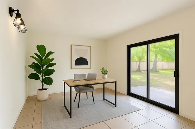 a living room with furniture and a potted plant