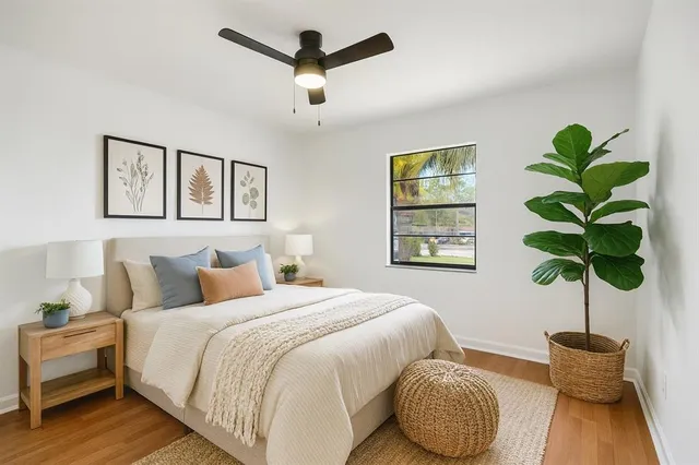 a bedroom with a bed potted plant and a window