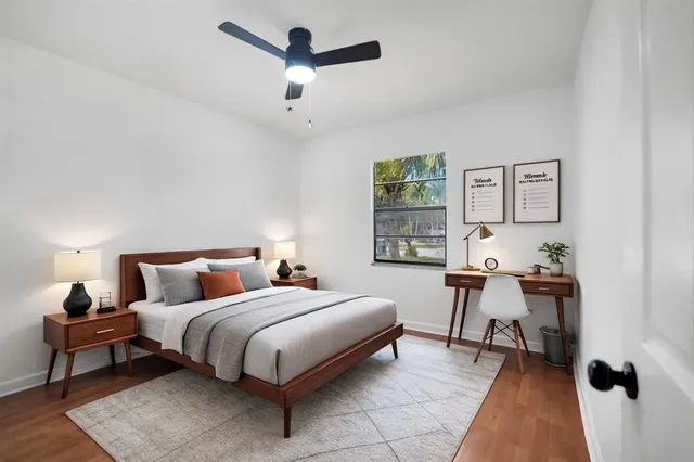 a bedroom with a bed and a desk