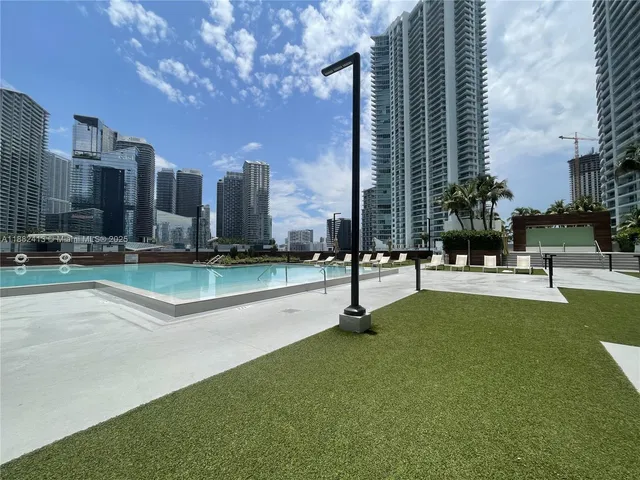 a swimming pool with outdoor seating and yard