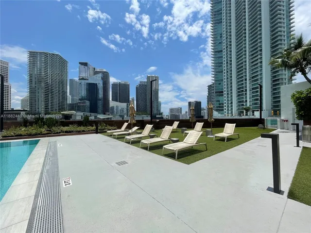 a view of swimming pool with chairs