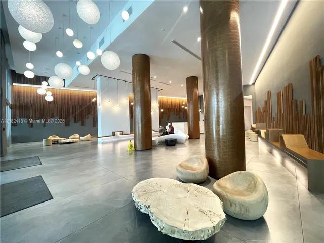 a living room with furniture and a large mirror