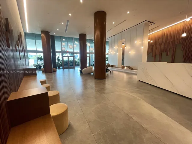 a lobby with furniture and a glass door