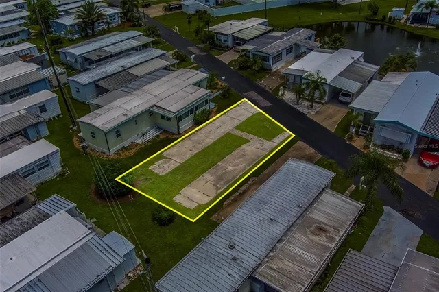an aerial view of a house with a garden and swimming pool