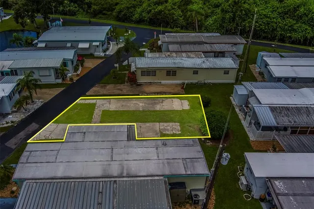 an aerial view of residential house with outdoor space and parking