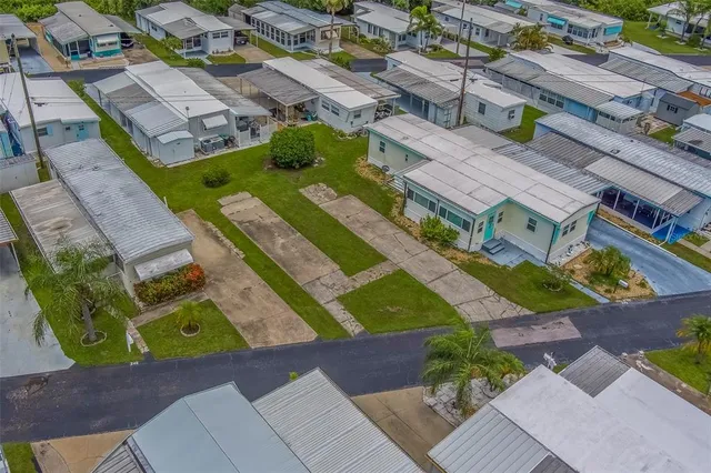an aerial view of multiple houses with yard