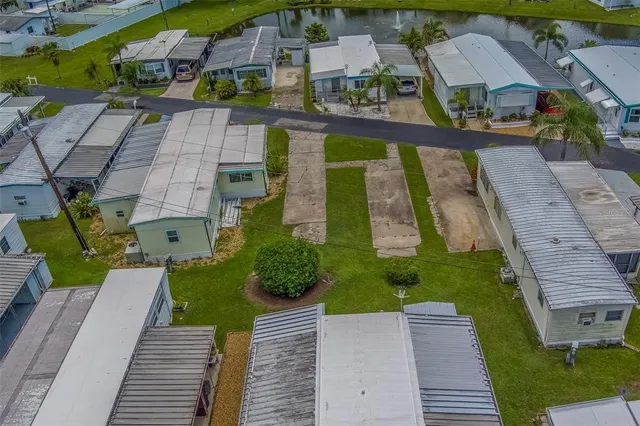 an aerial view of a residential houses with yard